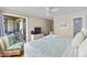 Comfortable main bedroom featuring balcony access, providing ocean views and a relaxing seating area with a plush chair at 201 76Th Ave. N # D-3, Myrtle Beach, SC 29572