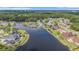 Aerial view showcasing waterfront homes, lush landscaping, and community lake at 2060 Woodburn Dr., Myrtle Beach, SC 29579