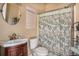 Cozy bathroom featuring a vanity, toilet, and a shower with a decorative shower curtain at 2060 Woodburn Dr., Myrtle Beach, SC 29579