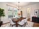 Sunlit dining room featuring a modern chandelier, large window, and stylish rug at 2060 Woodburn Dr., Myrtle Beach, SC 29579