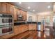 Bright kitchen with stainless steel appliances, wood cabinets, granite countertops, and hardwood floors at 2060 Woodburn Dr., Myrtle Beach, SC 29579