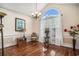 Living room featuring a modern chandelier, large arched window, and hardwood floors at 2060 Woodburn Dr., Myrtle Beach, SC 29579