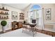 Home office featuring a large arched window, desk, shelves and hardwood floors at 2060 Woodburn Dr., Myrtle Beach, SC 29579