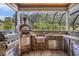 Fully equipped outdoor kitchen featuring a grill, pizza oven, granite countertop, and ample storage at 2060 Woodburn Dr., Myrtle Beach, SC 29579