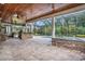 Inviting outdoor patio with a built-in grill, stone bar, ceiling fans, and a screened pool area at 2060 Woodburn Dr., Myrtle Beach, SC 29579