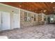 Covered outdoor patio featuring brick walls, a wooden ceiling with a ceiling fan, and tile flooring at 2060 Woodburn Dr., Myrtle Beach, SC 29579