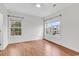 Bright bedroom featuring hardwood floors, white walls and two windows letting in natural light at 2061 Silvercrest Dr. # 7E, Myrtle Beach, SC 29579