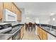 Traditional kitchen features wood cabinets, black countertops, a black oven, and stainless steel sink at 2061 Silvercrest Dr. # 7E, Myrtle Beach, SC 29579