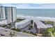 Aerial view of oceanfront condo complex with a beach view, parking, and landscaped grounds near the water at 207 N Ocean Blvd. # 342, North Myrtle Beach, SC 29582