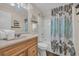 Bathroom with a wood vanity, framed mirror, shower/tub combination, and neutral accents at 207 N Ocean Blvd. # 342, North Myrtle Beach, SC 29582