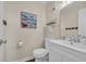 Half bathroom with a sleek white vanity, contemporary fixtures, and wood-look flooring at 207 N Ocean Blvd. # 342, North Myrtle Beach, SC 29582