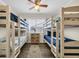 Bedroom featuring two sets of bunk beds, a ceiling fan, and shared nightstand storage at 207 N Ocean Blvd. # 342, North Myrtle Beach, SC 29582