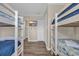 Bedroom with two sets of bunkbeds, closet, and a TV for a Gathering-friendly space at 207 N Ocean Blvd. # 342, North Myrtle Beach, SC 29582