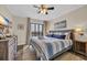 Bright bedroom features a queen bed with balcony access, a ceiling fan, and wood-look flooring at 207 N Ocean Blvd. # 342, North Myrtle Beach, SC 29582