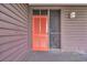 Condo entrance featuring a vibrant orange door and number 342 with brown siding at 207 N Ocean Blvd. # 342, North Myrtle Beach, SC 29582