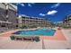 Spacious pool with a shallow end, surrounded by lounge chairs and lush greenery, offering a relaxing oasis at 207 N Ocean Blvd. # 342, North Myrtle Beach, SC 29582