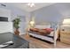 Cozy bedroom with trundle bed, warm lighting, and a decorative mirror enhancing the space at 211 76Th Ave. N # A3, Myrtle Beach, SC 29572