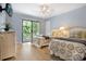 Well-lit bedroom with sliding glass doors to private balcony, adorned with two beds and wicker furniture at 211 76Th Ave. N # A3, Myrtle Beach, SC 29572