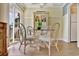 Cozy dining area featuring wicker chairs, a glass table, and natural light from a balcony at 211 76Th Ave. N # A3, Myrtle Beach, SC 29572