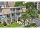 Charming villa with quaint balconies, lush lawn, and vibrant landscaping at 211 76Th Ave. N # A3, Myrtle Beach, SC 29572