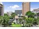 Charming multi-story villa with palm trees, manicured lawn, and white picket fence; coastal living at its finest at 211 76Th Ave. N # A3, Myrtle Beach, SC 29572