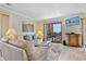 Comfortable living space with plush sofas, a TV, and balcony access offering ocean views at 211 76Th Ave. N # A3, Myrtle Beach, SC 29572