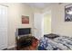 Well-lit bedroom showcases a TV, closet, and sports-themed decor at 2280 Andover Dr. # C, Surfside Beach, SC 29575