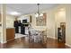 Bright dining area open to the kitchen featuring wood floors and natural light at 2280 Andover Dr. # C, Surfside Beach, SC 29575