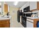 Functional kitchen featuring white cabinets, black appliances, and bright overhead lighting at 2280 Andover Dr. # C, Surfside Beach, SC 29575