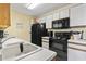 Kitchen showcases white cabinets, black appliances, and ample counter space at 2280 Andover Dr. # C, Surfside Beach, SC 29575