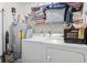 Functional laundry area includes washer, dryer, hot water heater, and overhead storage at 2280 Andover Dr. # C, Surfside Beach, SC 29575