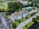 Aerial shot of complex with manicured lawns, mature trees, and a pond at 2280 Andover Dr. # L, Surfside Beach, SC 29575