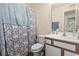 Bathroom with a single sink vanity and a blue patterned shower curtain over the bathtub at 2280 Andover Dr. # L, Surfside Beach, SC 29575