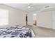 Spacious bedroom features two doorways, ceiling fan and neutral colored walls and carpet at 2280 Andover Dr. # L, Surfside Beach, SC 29575