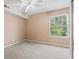 Neutral carpeted bedroom with window and ceiling fan at 2280 Andover Dr. # L, Surfside Beach, SC 29575