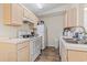 Galley kitchen with white appliances and light wood cabinetry at 2280 Andover Dr. # L, Surfside Beach, SC 29575