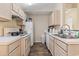 Galley kitchen with white appliances and light wood cabinetry at 2280 Andover Dr. # L, Surfside Beach, SC 29575