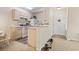 Kitchen area with wood cabinets, white appliances, and a breakfast bar at 2280 Andover Dr. # L, Surfside Beach, SC 29575
