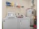 Laundry area with washing machine, dryer, water heater and storage shelf with cleaning supplies at 2280 Andover Dr. # L, Surfside Beach, SC 29575