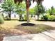 A serene backyard featuring lush landscaping, a palm tree and vibrant green grass at 230 Vermillion Dr., Little River, SC 29566