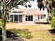Exterior of the house showing a yard with grass, and a screened porch at 230 Vermillion Dr., Little River, SC 29566