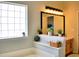 Well-lit bathroom with a tub and a built-in shelf with decorative plants at 230 Vermillion Dr., Little River, SC 29566