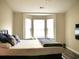 Bright bedroom with hardwood floors, sun-filled windows, and a comfortable queen sized bed at 230 Vermillion Dr., Little River, SC 29566