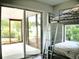 Bedroom with screen porch access featuring bunkbeds and natural light at 230 Vermillion Dr., Little River, SC 29566