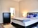 Comfortable bedroom featuring a black metal bed frame and an ensuite bathroom at 230 Vermillion Dr., Little River, SC 29566