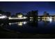 Community pond at night with illuminated fountain and well-lit surroundings at 230 Vermillion Dr., Little River, SC 29566