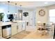 Bright eat-in kitchen with stainless appliances, stylish lighting, and a view to the living area at 230 Vermillion Dr., Little River, SC 29566