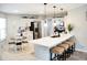 Bright, open kitchen features white cabinets, stainless steel appliances, and a large island with seating at 230 Vermillion Dr., Little River, SC 29566