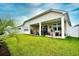 View of the well-maintained backyard with patio, seating, and privacy fence at 234 Rolling Woods Ct., Little River, SC 29566