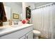 Bright bathroom with white vanity, framed art, decorative shelf, and shower with curtain at 234 Rolling Woods Ct., Little River, SC 29566